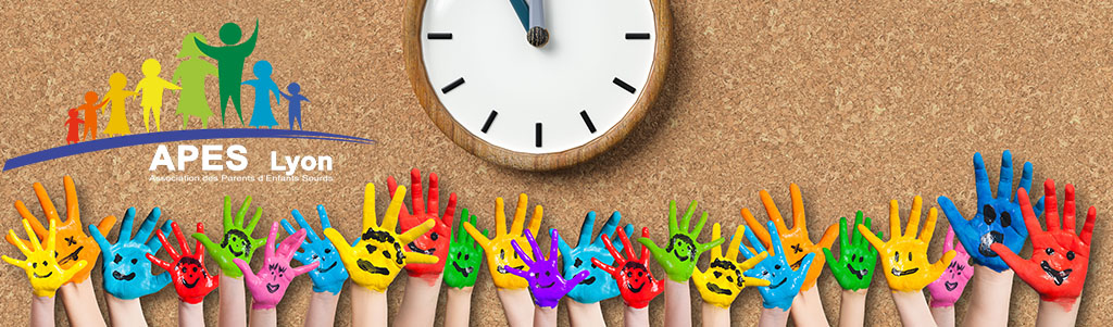 painted kids hands with smiley emoticons in front of cork background with a clock